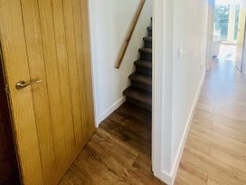 A hallway with a door and a staircase at 2A Hamilton Road in Felixstowe