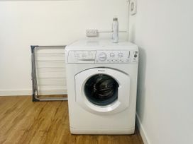 A washing machine with a drying rack and a water bottle at 2A Hamilton Road in Felixstowe
