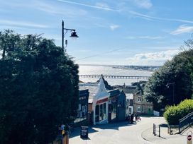 A view of the sea and pier with buildings on a street at 2A Hamilton Road Felixstowe