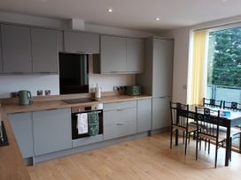 A kitchen with cabinets and a table at 2B Hamilton Road in Felixstowe
