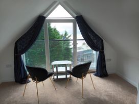 A snug with chairs and a table by a window at 2B Hamilton Road in Felixstowe