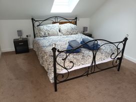 A bedroom with a bed and bedside tables at 2B Hamilton Road in Felixstowe