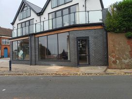 A building with large windows and balcony at 2B Hamilton Road Felixstowe