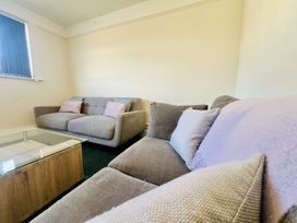 A living room with sofas and a coffee table at 11 Langer Road in Felixstowe