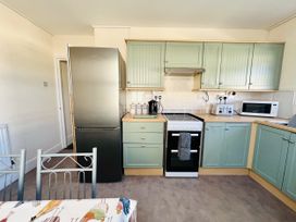 A kitchen with appliances and cabinets at 11 Langer Road, Felixstowe