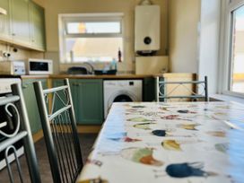 A kitchen with a table and chairs at 11 Langer Road in Felixstowe