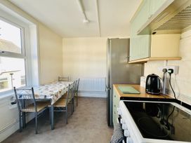 A kitchen with table and chairs at 11 Langer Road in Felixstowe