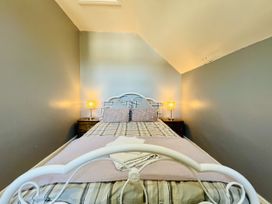 A bedroom with a bed and bedside table with lamp at 11 Langer Road Felixstowe