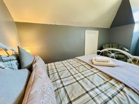 A bedroom with a bed and a chair at 11 Langer Road in Felixstowe