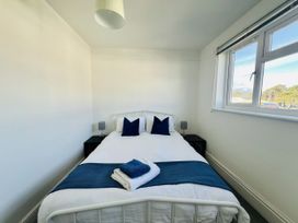 A bedroom with a bed and bedside tables at 11 Langer Road in Felixstowe