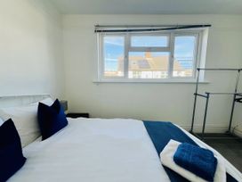 A bedroom with a bed and window at 11 Langer Road, Felixstowe