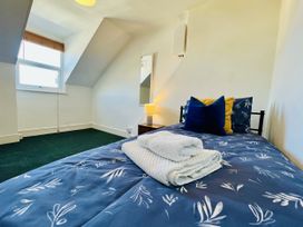 A bedroom with a bed and bedside lamp at 11 Langer Road in Felixstowe