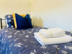 A bed with towels and pillows at 11 Langer Road, Felixstowe