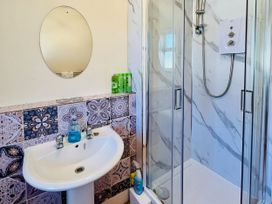 A bathroom with a sink and shower at 11 Langer Road in Felixstowe