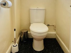 A bathroom with a toilet and toilet roll at 11 Langer Road in Felixstowe