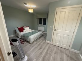 A bedroom with a bed and fan at 14 Becket Close Woodford Green