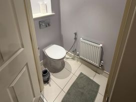 A bathroom with a toilet and radiator at 14 Becket Close Woodford Green