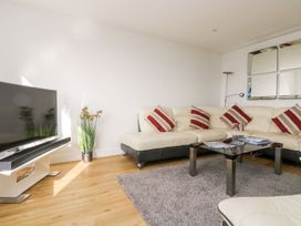 A living room with a sofa and television at Praa Waves in Penzance