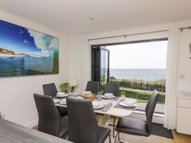 A dining room with a sea view at Praa Waves in Penzance