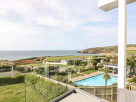A view of the ocean and swimming pool at Praa Waves in Penzance