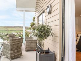 A balcony with chairs and a planter at Praa Waves in Penzance