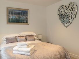 A bedroom with a bed and decorative items at Praa Waves in Penzance