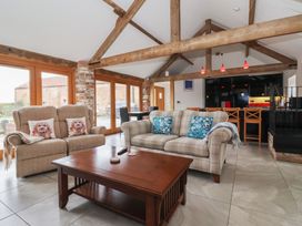A living room with a sofa and coffee table at Pillar Barn Driffield