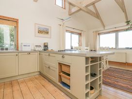 A kitchen with an island and a bread box at Harbour Lights in Penzance