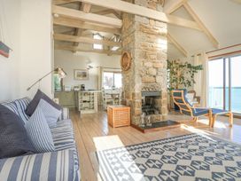 A living room with a fireplace and seating area at Harbour Lights in Penzance