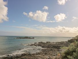 A view of the sea with rocky shore and clouds at Harbour Lights in Penzance