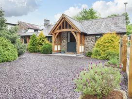An entrance of a house with a garden and pathway at The Talkhouse Cottage in Caersws