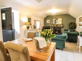 A dining area with a table and chairs at The Talkhouse Cottage in Caersws