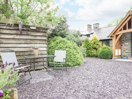 An outdoor space with a table and chairs at The Talkhouse Cottage in Caersws