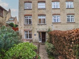 A building with windows and a door at Waterloo Mill Cottage in Wotton-Under-Edge