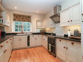 A kitchen with cabinets and an oven at Waterloo Mill Cottage Wotton-Under-Edge