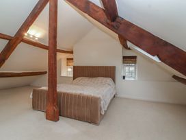 A bedroom with a bed and window at Waterloo Mill Cottage Wotton-Under-Edge