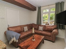 A living room with a sofa and coffee table at Waterloo Mill Cottage in Wotton-Under-Edge