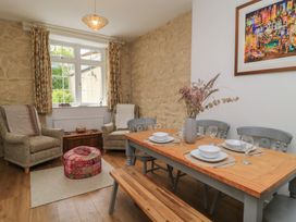 A dining room with table and chairs at Waterloo Mill Cottage Wotton-Under-Edge