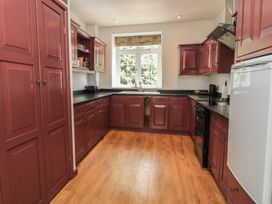 A kitchen with cabinets and appliances at Waterloo Mill Cottage Wotton-Under-Edge
