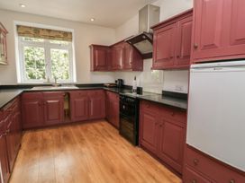 A kitchen with cabinets and countertop at Waterloo Mill Cottage in Wotton-Under-Edge