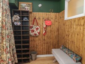 An entryway with storage cubby and hooks at Waterloo Mill Cottage in Wotton-Under-Edge