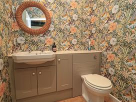 A bathroom with a wash basin and toilet at Waterloo Mill Cottage in Wotton-Under-Edge