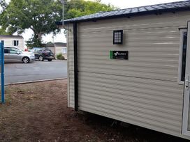 A caravan with a sign and door at Caravan Thorness Bay Holiday Park Thorness Lane
