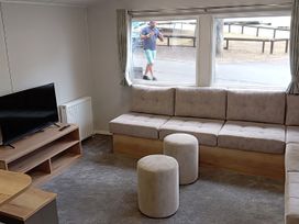 A living room with a sofa and television at Caravan Thorness Bay Holiday Park Thorness Lane