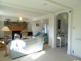 A living room with a fireplace and sofa at Mount Pleasant in Padstow