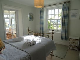 A bedroom with a bed and towels on it at Mount Pleasant in Padstow
