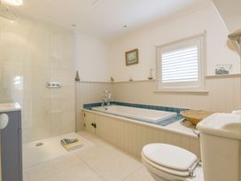 A bathroom with a bathtub and shower at Mount Pleasant in Padstow