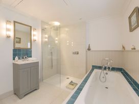 A bathroom with a bathtub and shower at Mount Pleasant in Padstow