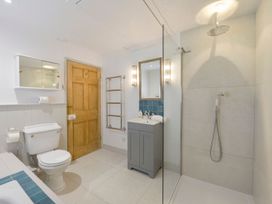 A bathroom with a shower, sink, and toilet at Mount Pleasant in Padstow