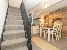 A dining room with a table and chairs at Driftwood Cottage Helston